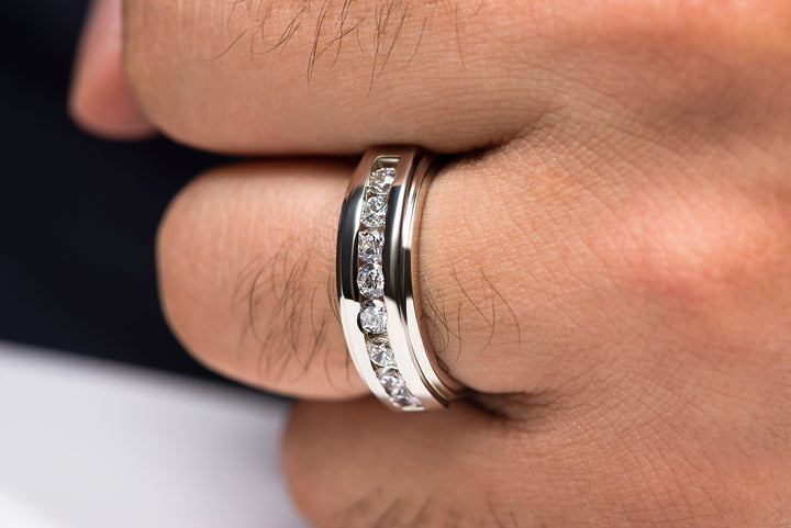 Man wearing elegant moissanite engagement ring in silver