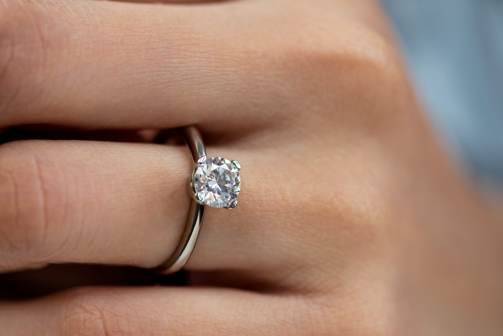 Model showcasing 1 carat 4 prong moissanite ring in silver